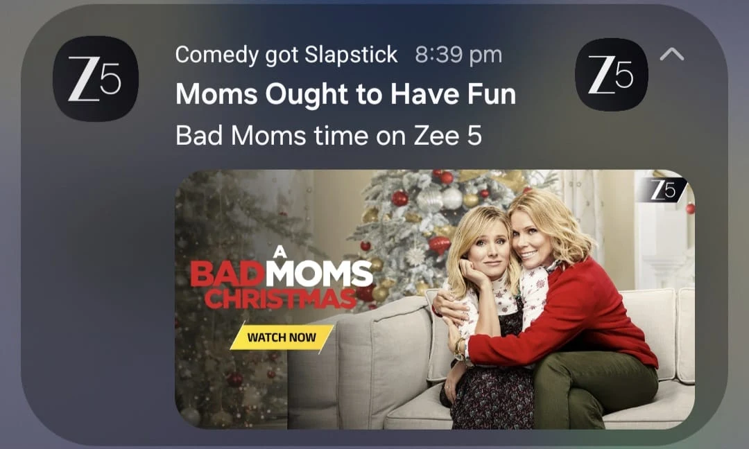 ZEE5 push notification: 'Comedy got Slapstick' with the headline 'Moms Ought to Have Fun' and the line 'Bad Moms time on Zee 5', over A Bad Moms Christmas key art.